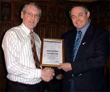 Dennis receives his certificate from Dennis Taylor